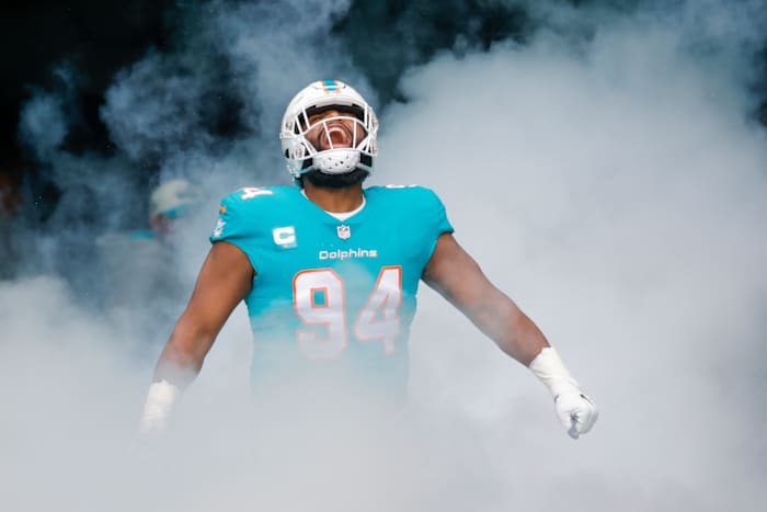 Miami Dolphins defensive tackle Christian Wilkins looks up yelling in celebration as smoky fog comes up around him